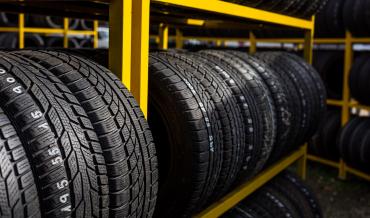 several tires on a yellow rack