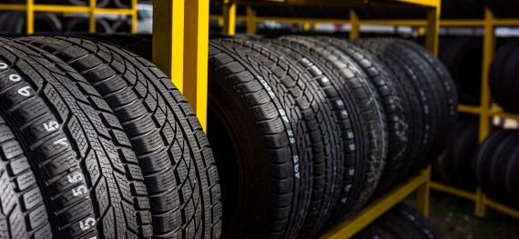 several tires on a yellow rack