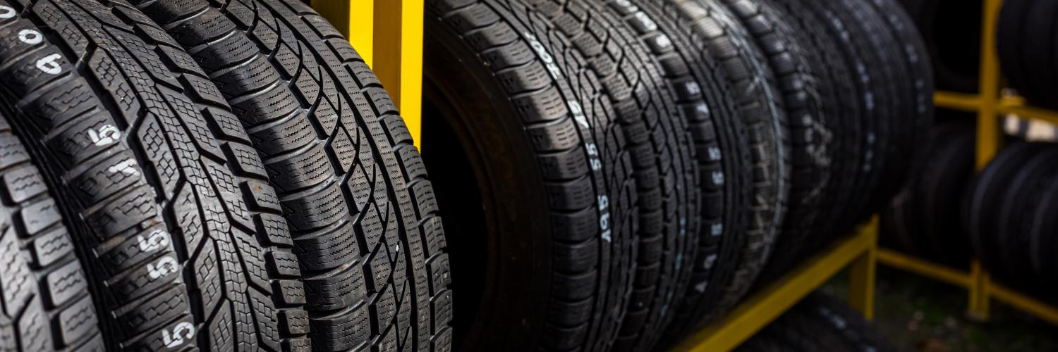 several tires on a yellow rack